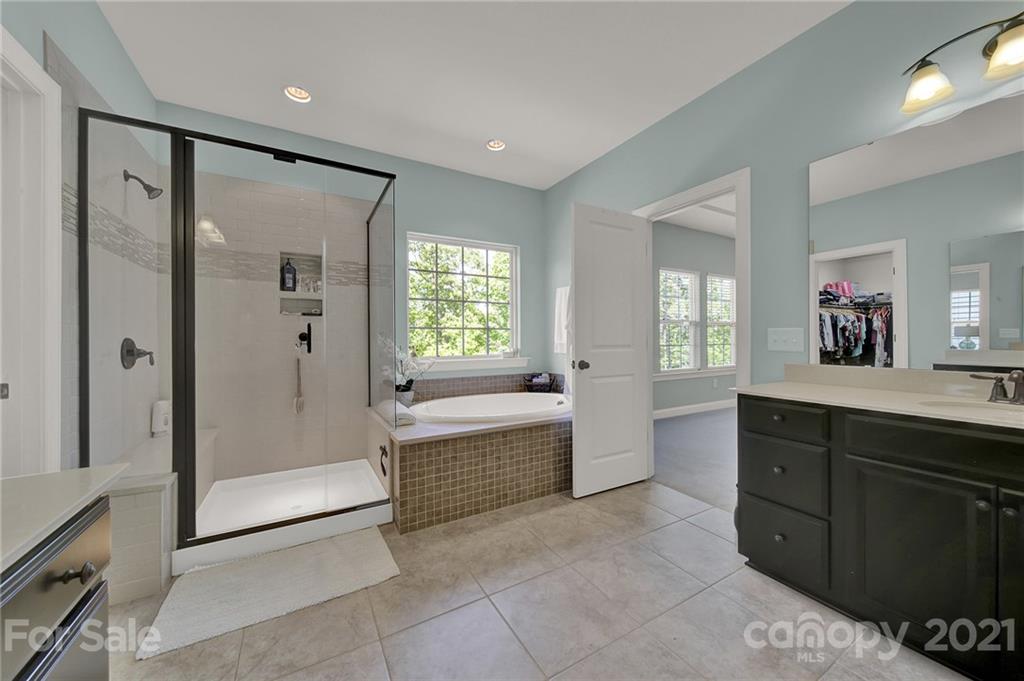 1033 Emory Lane Fort Mill, SC 29708 - Photo 34 of 48 a spacious bathroom with a tub sink shower and mirror