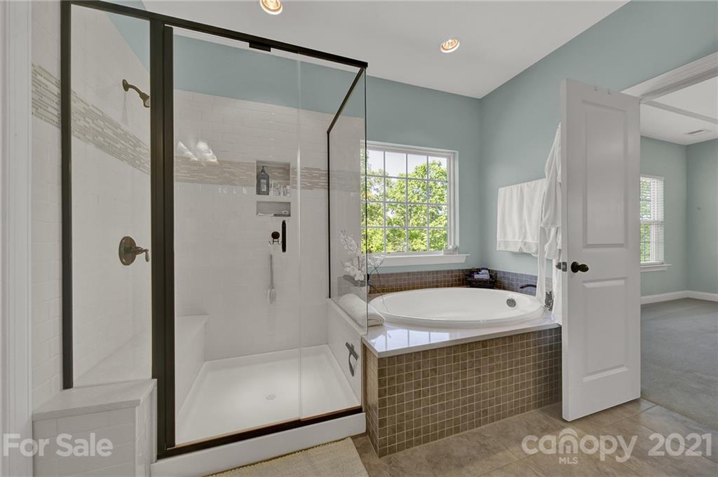 1033 Emory Lane Fort Mill, SC 29708 - Photo 35 of 48 a bathroom with a sink a mirror and a bathtub