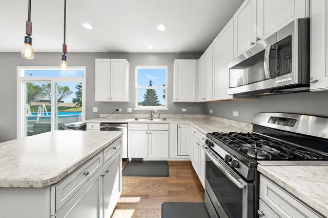 a kitchen with a sink stove and cabinets