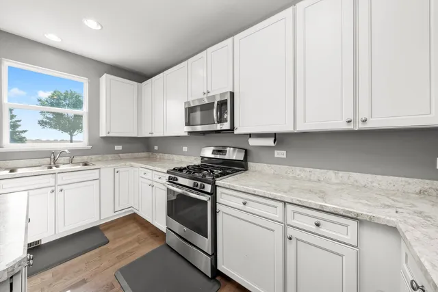 a bathroom with a sink mirror and toilet