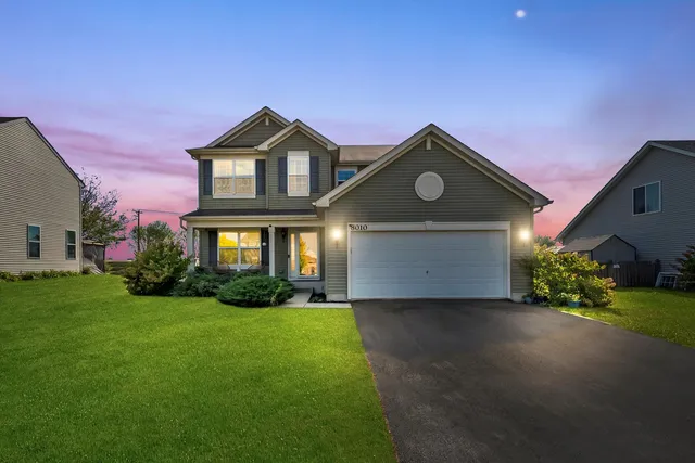 a front view of a house with a yard and garage