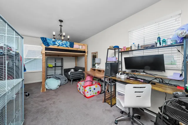 a view of a hallway with wooden floor and stairs