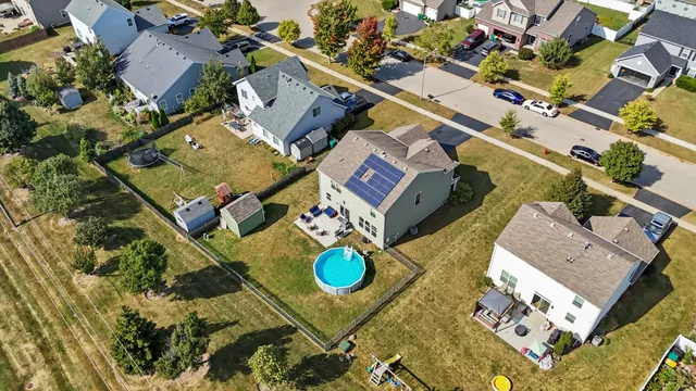 an aerial view of residential house with outdoor space and parking