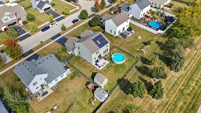 an aerial view of a house with a swimming pool