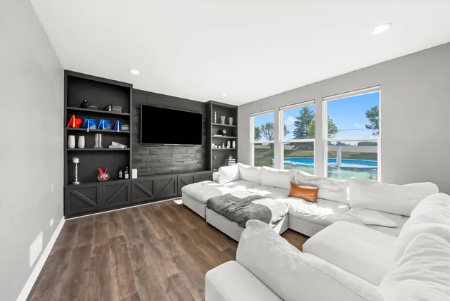 a living room with furniture and a large window