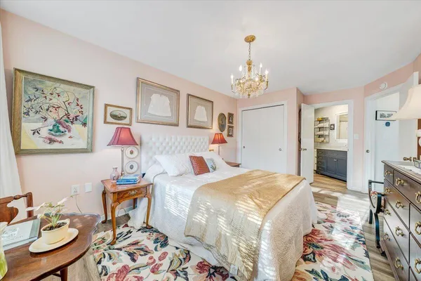 a bed sitting in a bedroom next to a window