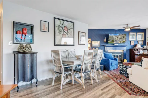 a living room with fireplace furniture and a large window
