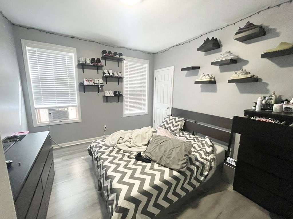 9 Mt Pleasant Avenue, Unit 3 Boston, MA 02119 - Photo 11 of 19 a bedroom with a bed and a window