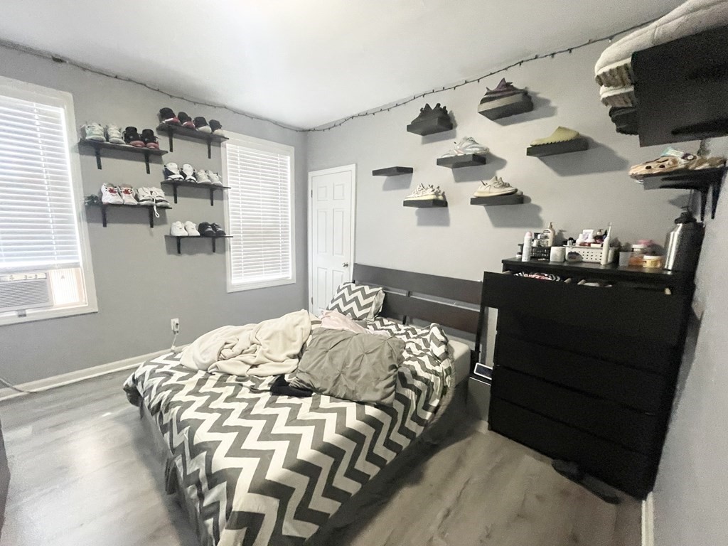 9 Mt Pleasant Avenue, Unit 3 Boston, MA 02119 - Photo 12 of 19 a bedroom with a bed and flat tv screen on the dresser