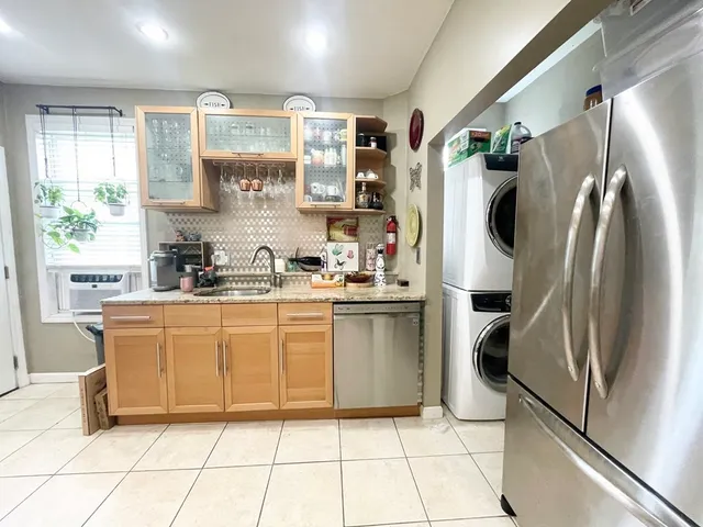 a kitchen with stainless steel appliances a refrigerator sink and microwave