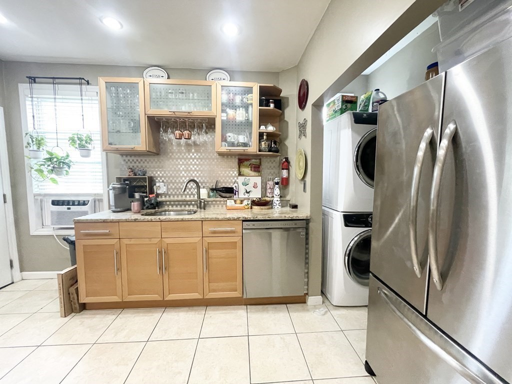 9 Mt Pleasant Avenue, Unit 3 Boston, MA 02119 - Photo 2 of 19 a kitchen with stainless steel appliances a refrigerator sink and microwave