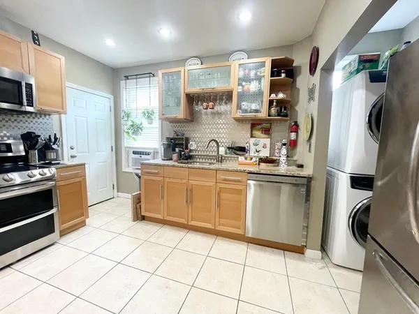 a kitchen with stainless steel appliances a refrigerator sink and microwave
