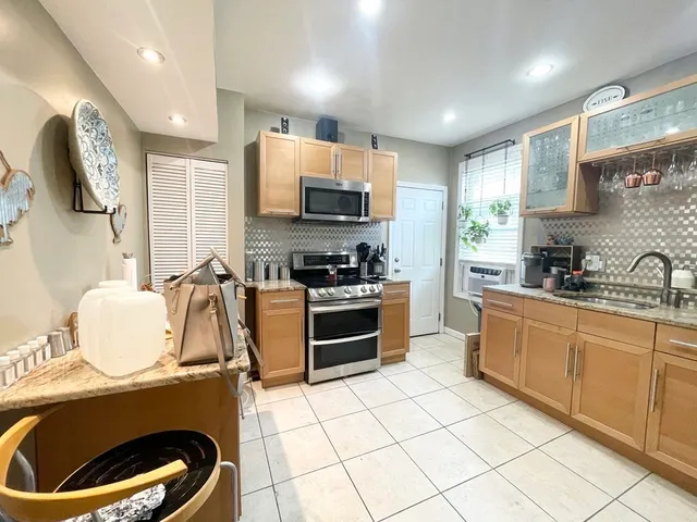 a kitchen with a stove a sink and a microwave