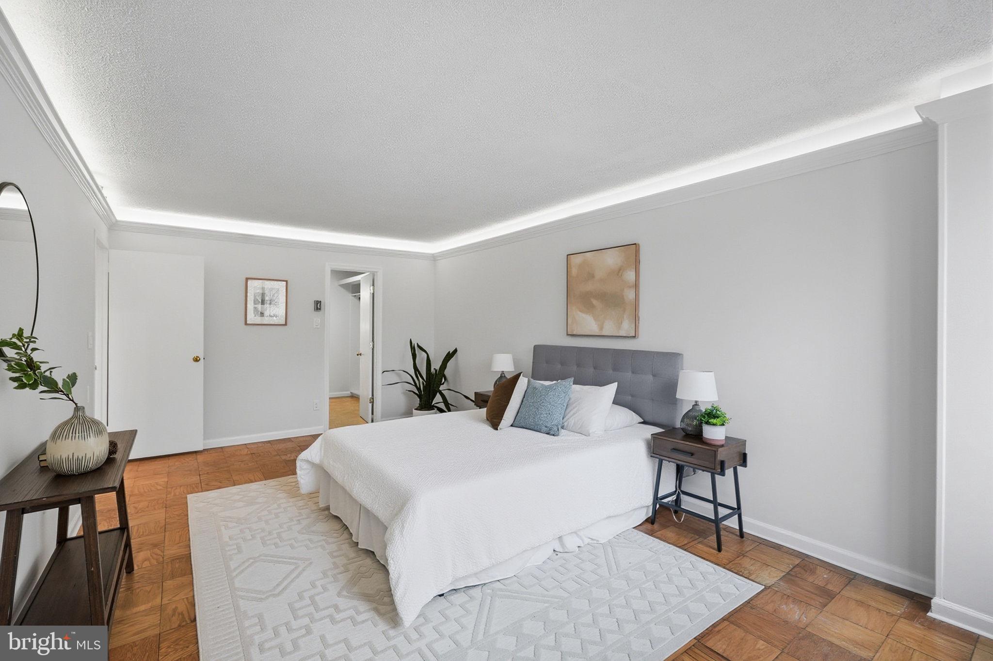3001 Veazey Street Northwest, Unit 116 Washington, DC 20008 - Photo 15 of 40 a spacious bedroom with a bed and a table in it