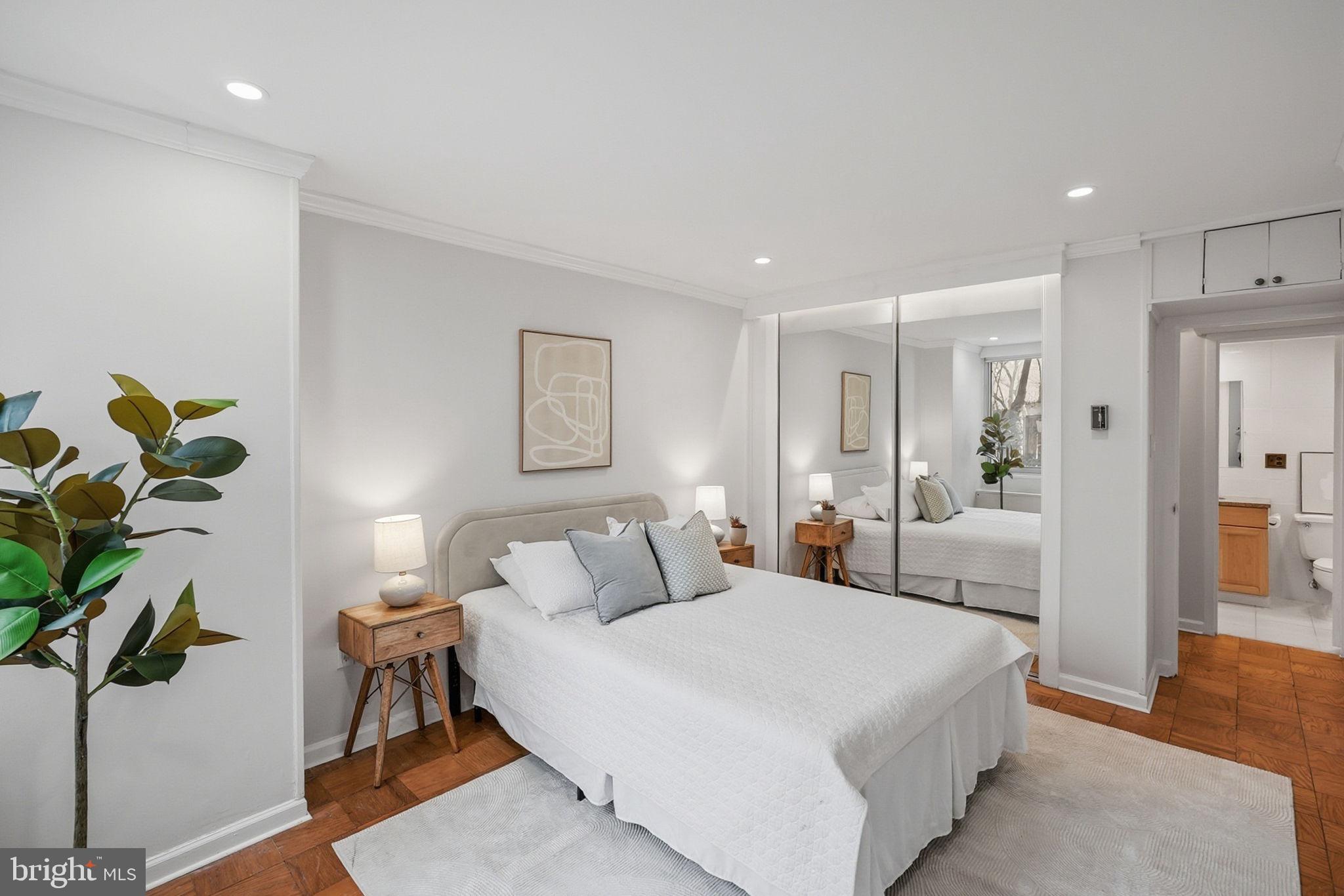 3001 Veazey Street Northwest, Unit 116 Washington, DC 20008 - Photo 21 of 40 a bedroom with a balcony a bed and a potted plant