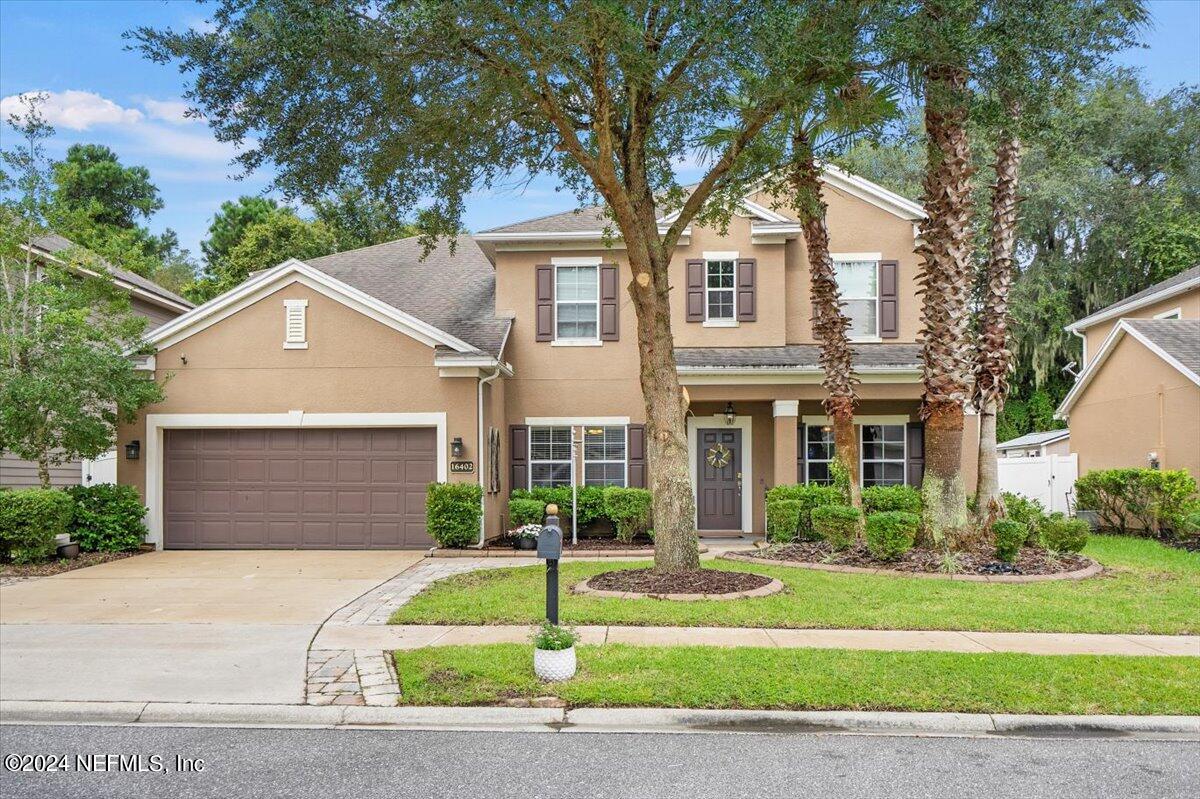 16402 Tisons Bluff Road Jacksonville, FL 32218 - Photo 1 of 45 a front view of a house with a yard and garage