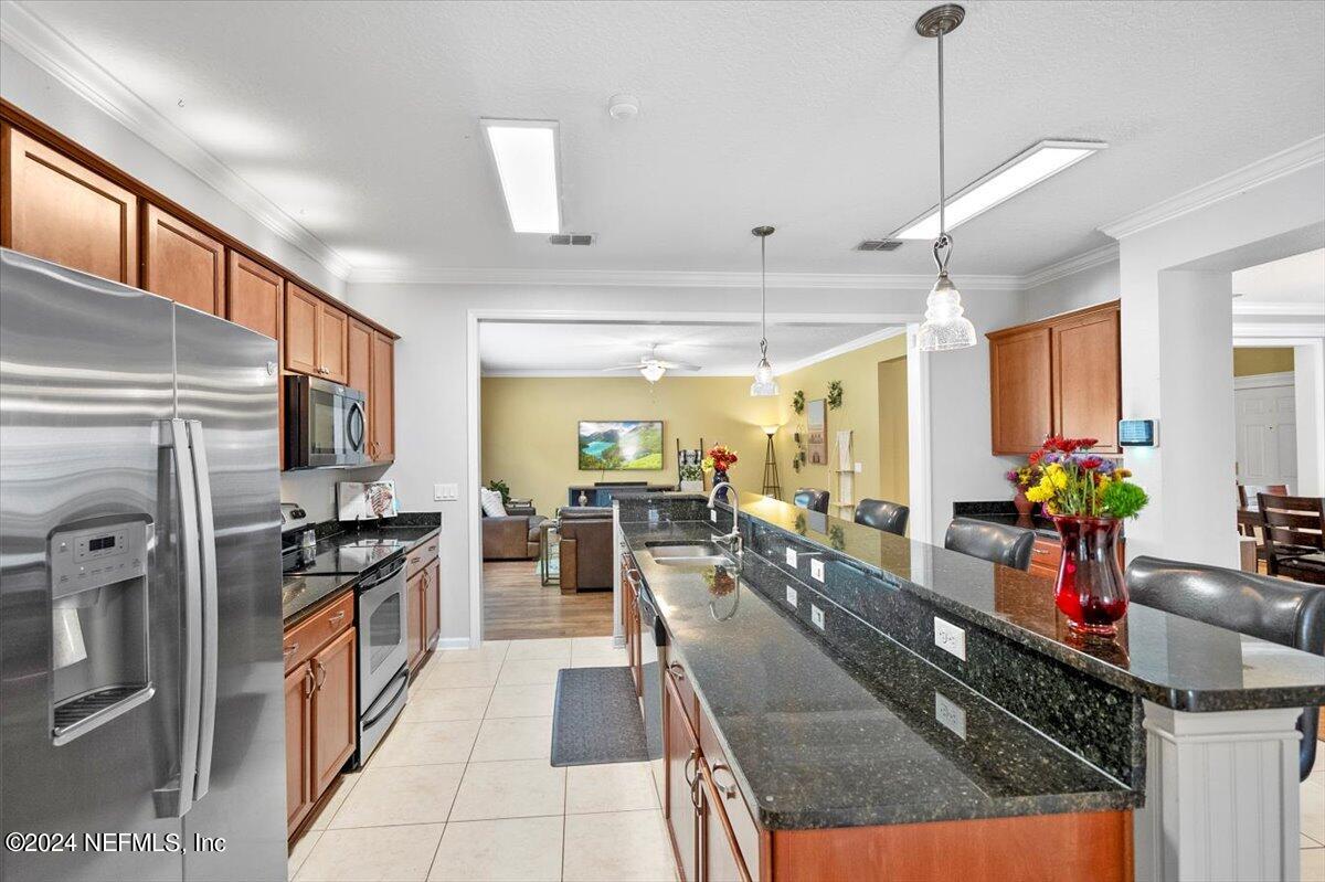 16402 Tisons Bluff Road Jacksonville, FL 32218 - Photo 12 of 45 a kitchen with stainless steel appliances granite countertop sink stove top oven refrigerator and cabinets