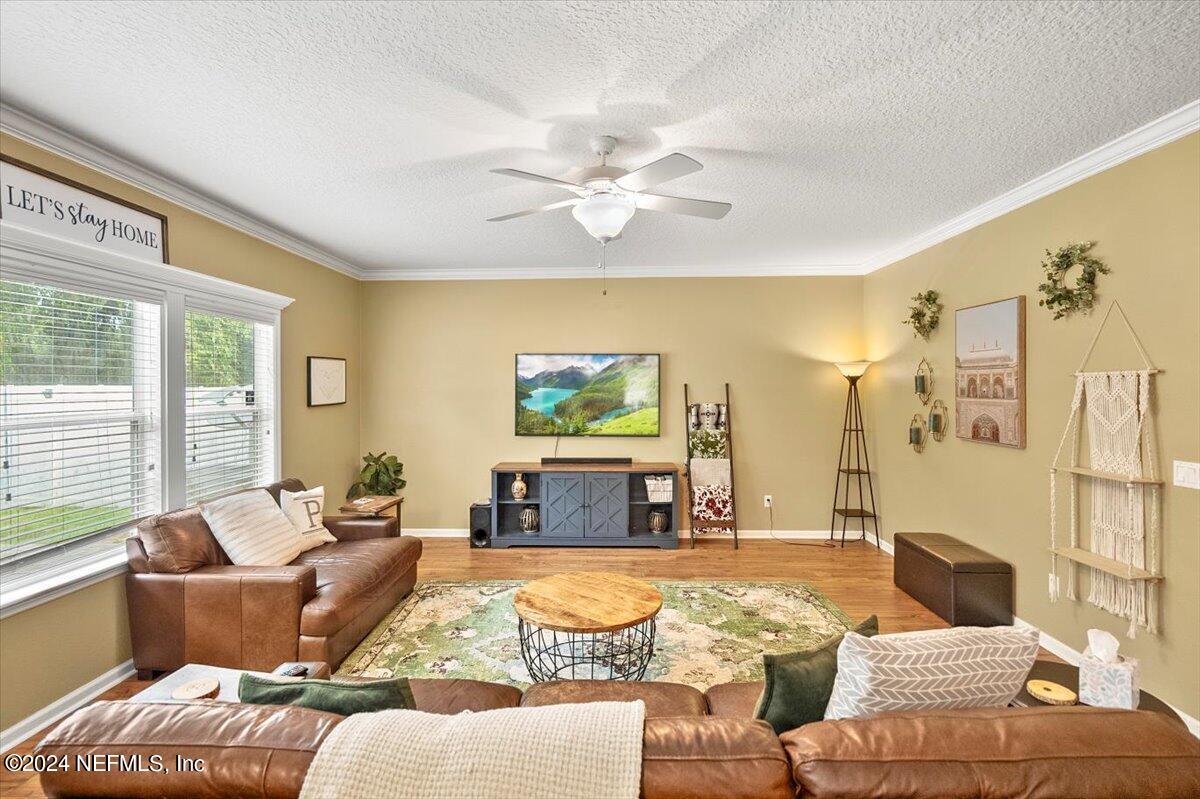16402 Tisons Bluff Road Jacksonville, FL 32218 - Photo 13 of 45 a living room with furniture and a large window