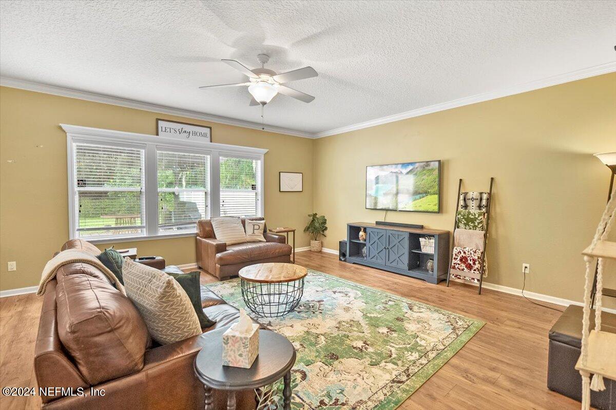 16402 Tisons Bluff Road Jacksonville, FL 32218 - Photo 14 of 45 a living room with furniture and a large window