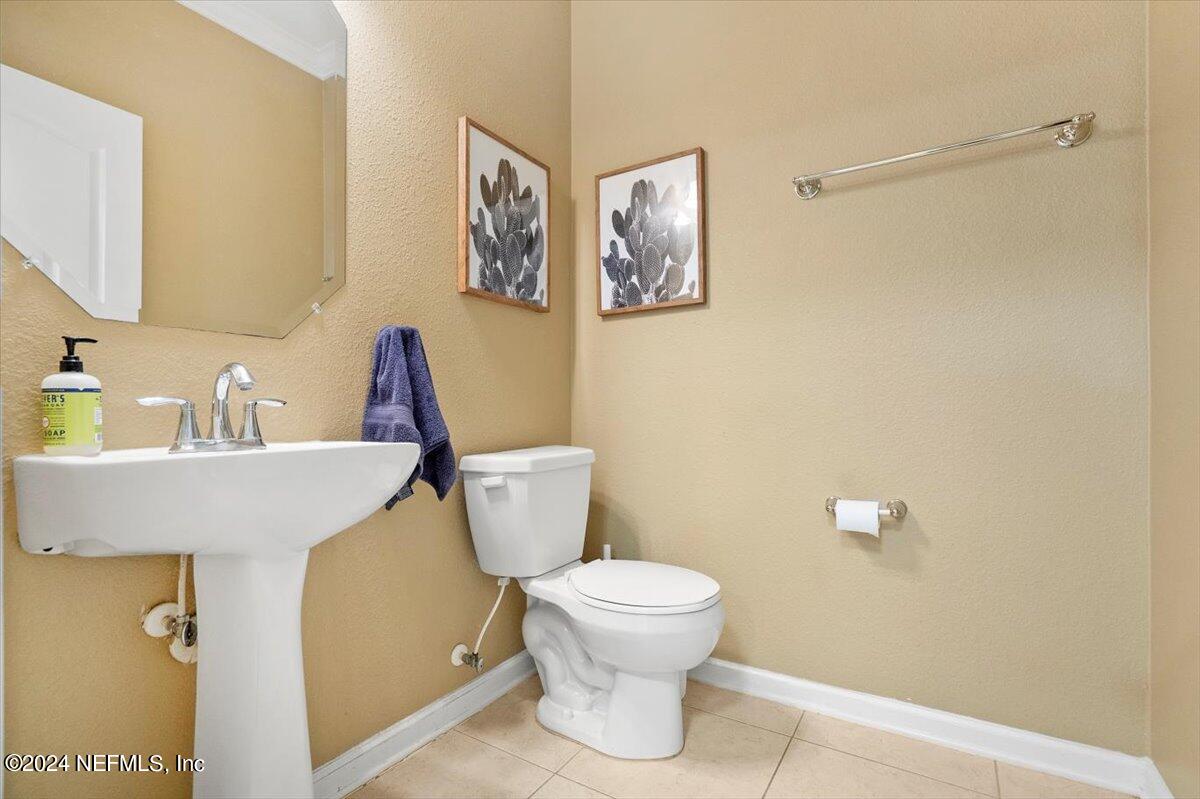 16402 Tisons Bluff Road Jacksonville, FL 32218 - Photo 18 of 45 a bathroom with a sink and a toilet