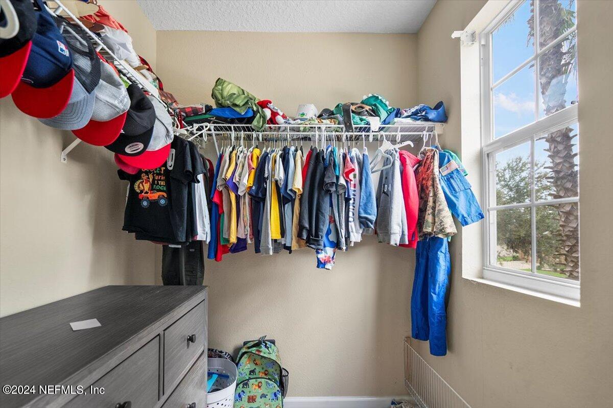 16402 Tisons Bluff Road Jacksonville, FL 32218 - Photo 22 of 45 a view of walk in closet with clothes
