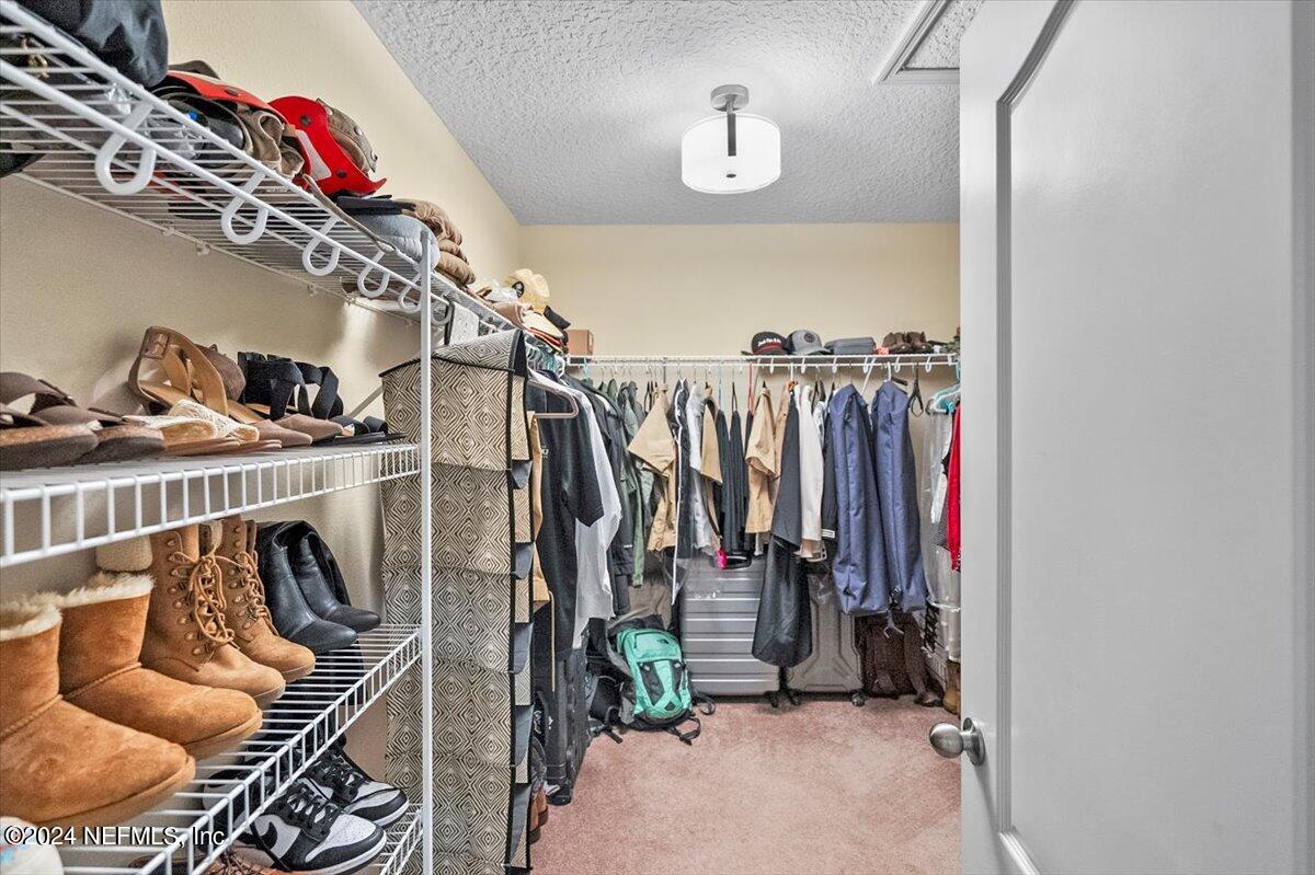 16402 Tisons Bluff Road Jacksonville, FL 32218 - Photo 26 of 45 a view of walk in closet with clothes