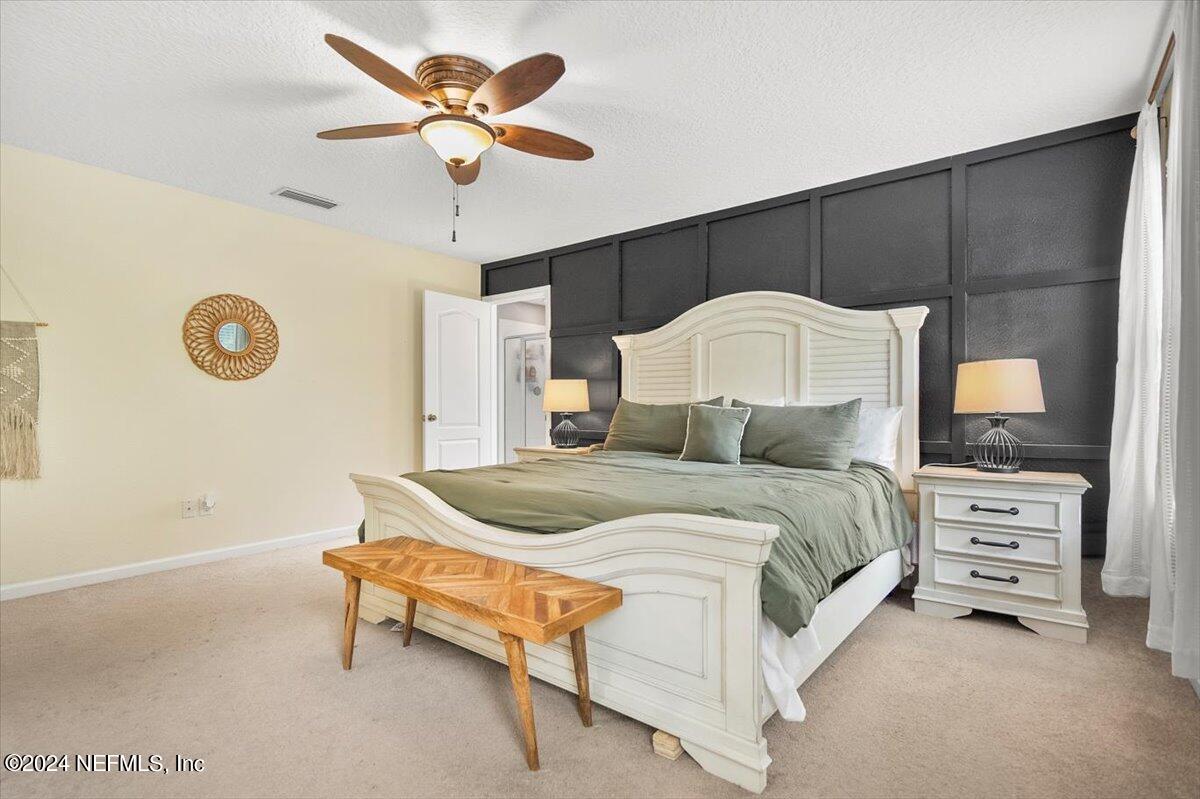 16402 Tisons Bluff Road Jacksonville, FL 32218 - Photo 27 of 45 a bedroom with a bed and a chandelier
