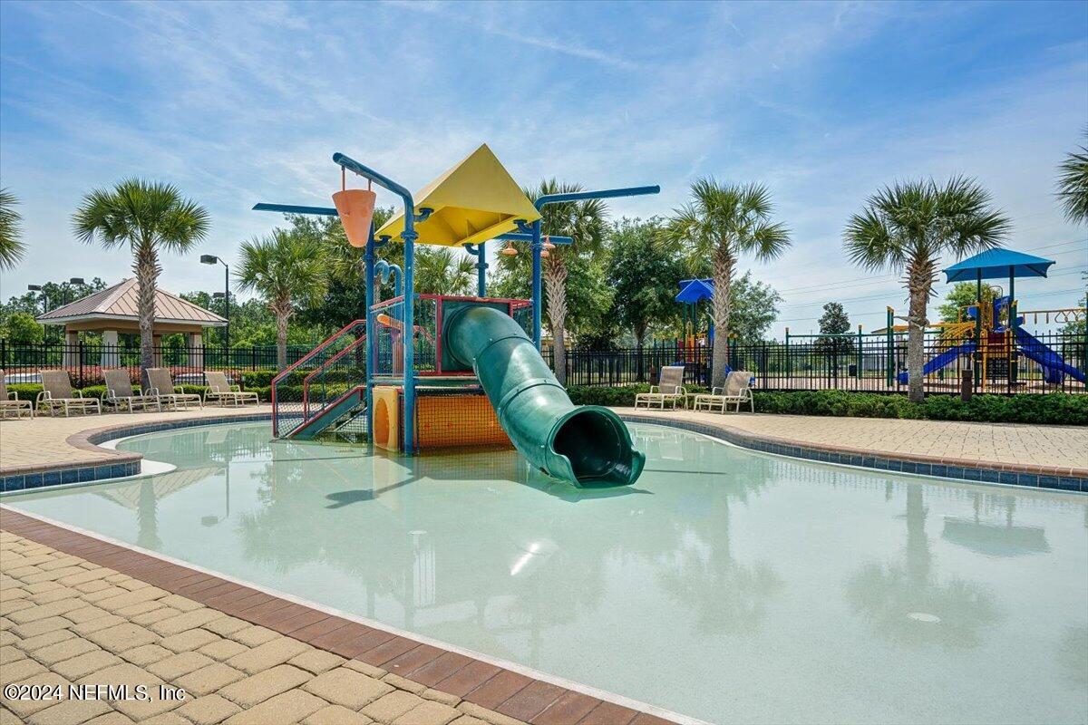 16402 Tisons Bluff Road Jacksonville, FL 32218 - Photo 40 of 45 a view of a swimming pool with a lounge chair and palm trees