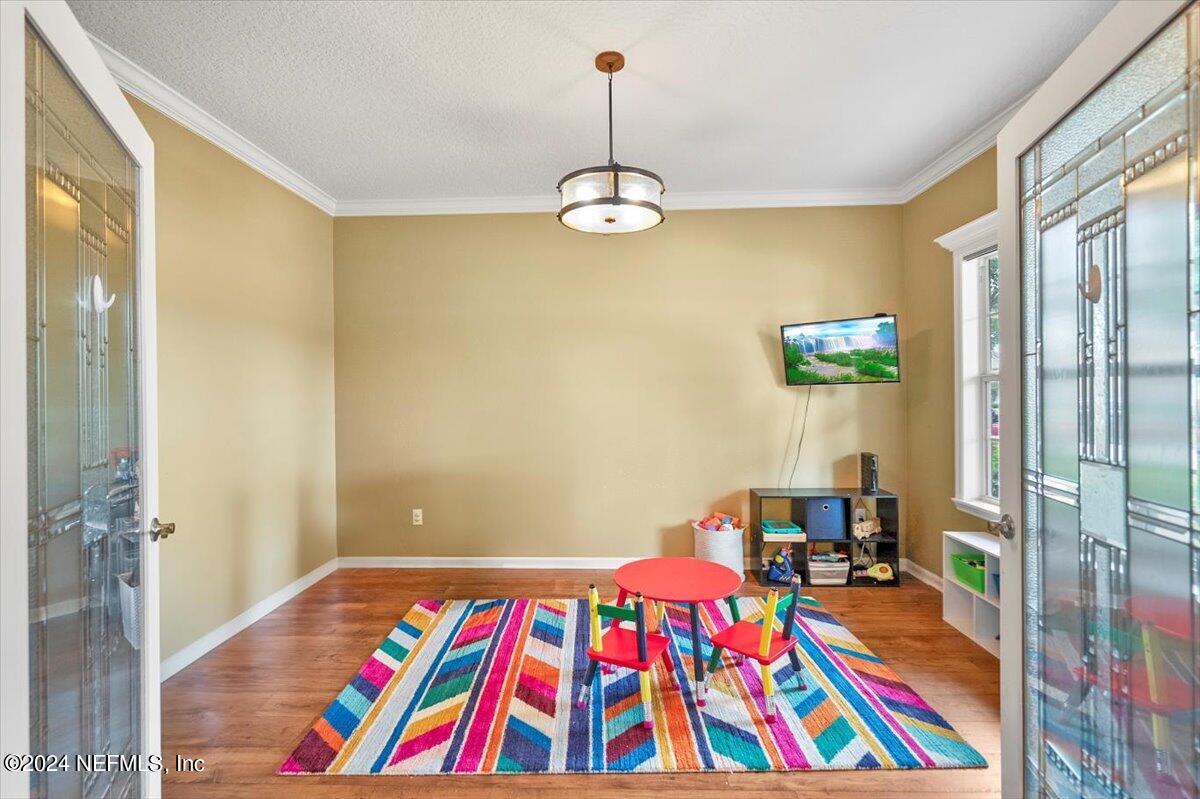 16402 Tisons Bluff Road Jacksonville, FL 32218 - Photo 5 of 45 a bedroom with a bed and a book shelf