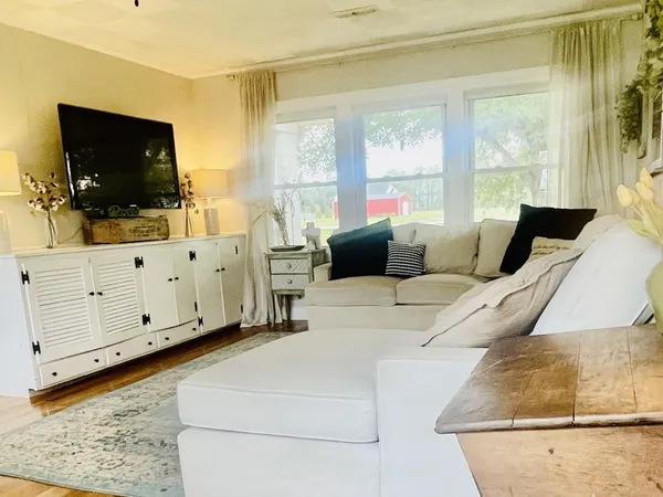 a bedroom with furniture and flat screen tv