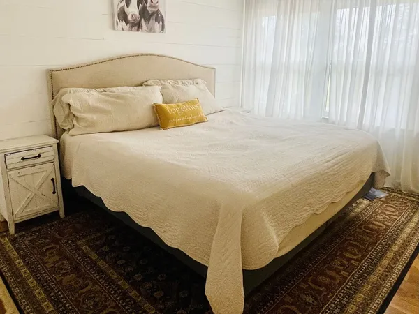 a bed sitting in a bedroom next to a window