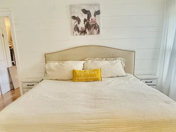 a large white bed in a small room