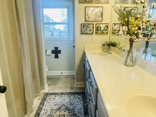 a bathroom with a sink and mirror with bathtub