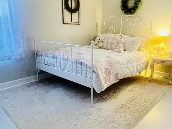 a bedroom with a bed and a chair