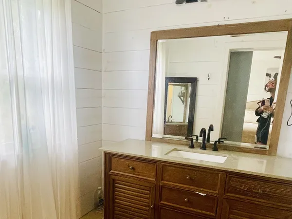 a bathroom with a double vanity sink and a mirror