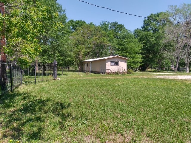 14633 Half Circle Splendora, TX 77372 - Photo 3 of 11 a house view with a garden space