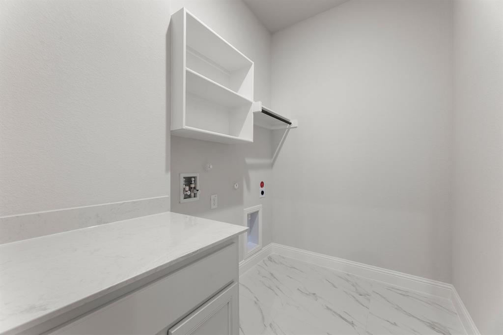14422 Mietner Street Pilot Point, TX 76258 - Photo 14 of 23 a view of a kitchen with white cabinets and a window