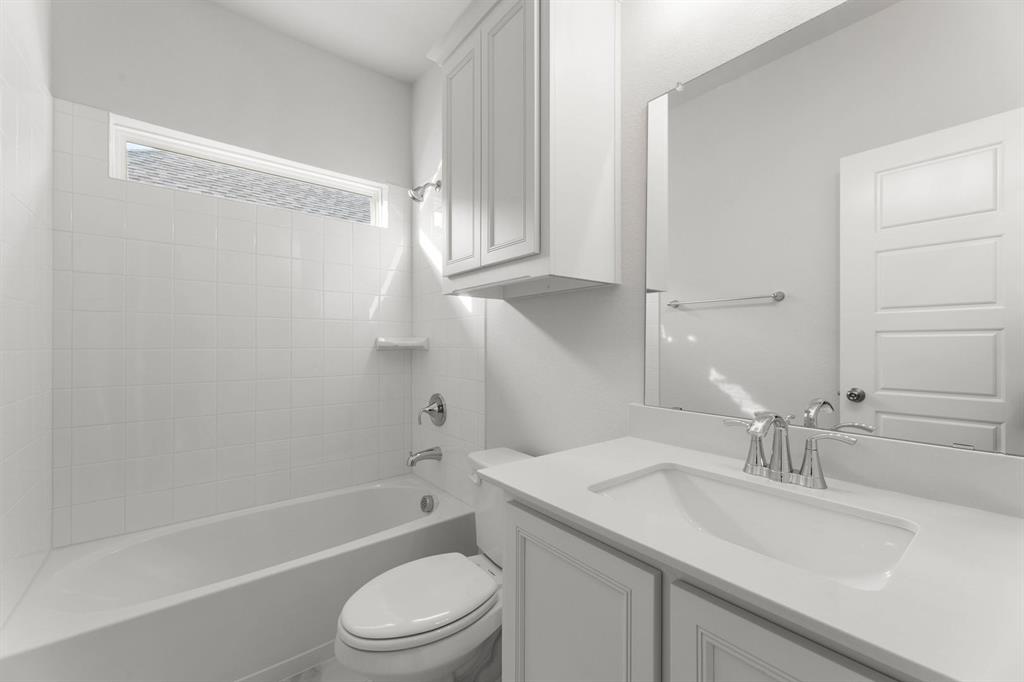 14422 Mietner Street Pilot Point, TX 76258 - Photo 17 of 23 a bathroom with a granite countertop sink toilet and shower