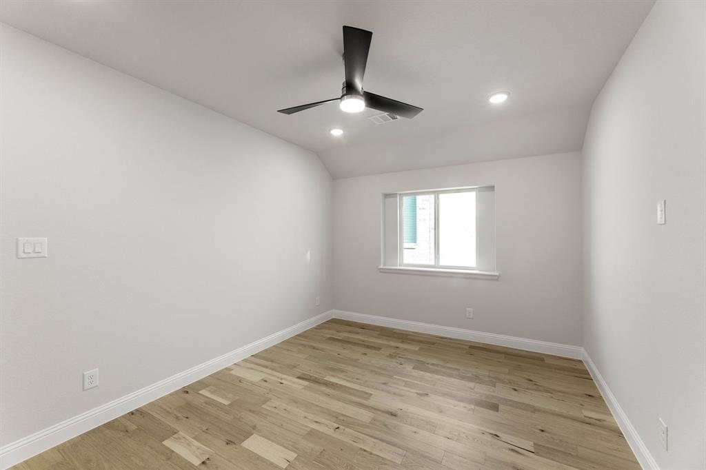 14422 Mietner Street Pilot Point, TX 76258 - Photo 18 of 23 an empty room with wooden floor ceiling fan and window
