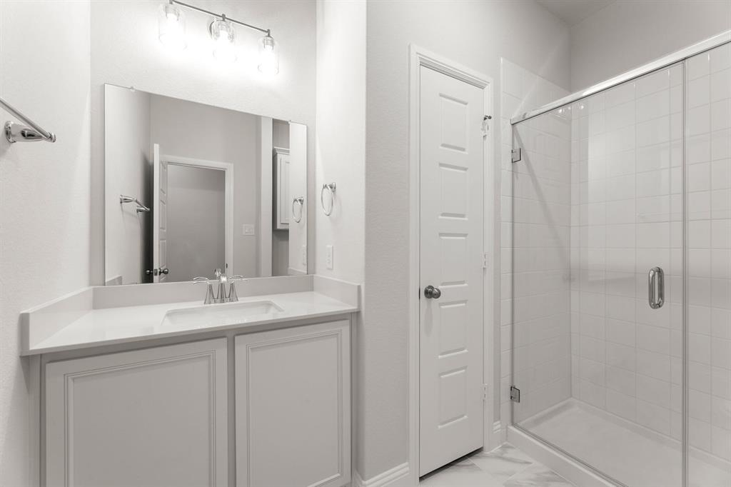14422 Mietner Street Pilot Point, TX 76258 - Photo 20 of 23 a bathroom with a shower sink and mirror