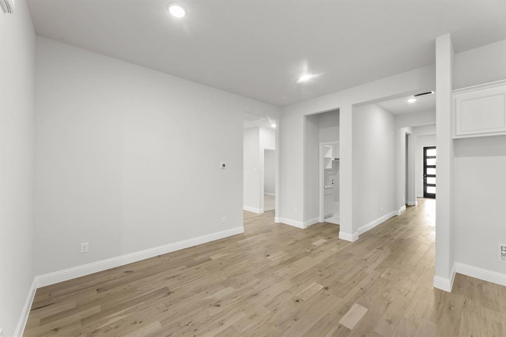 14422 Mietner Street Pilot Point, TX 76258 - Photo 2 of 23 a view of a hallway with wooden floor
