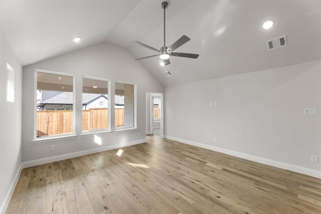 14422 Mietner Street Pilot Point, TX 76258 - Photo 3 of 23 a view of an empty room with a window and wooden floor