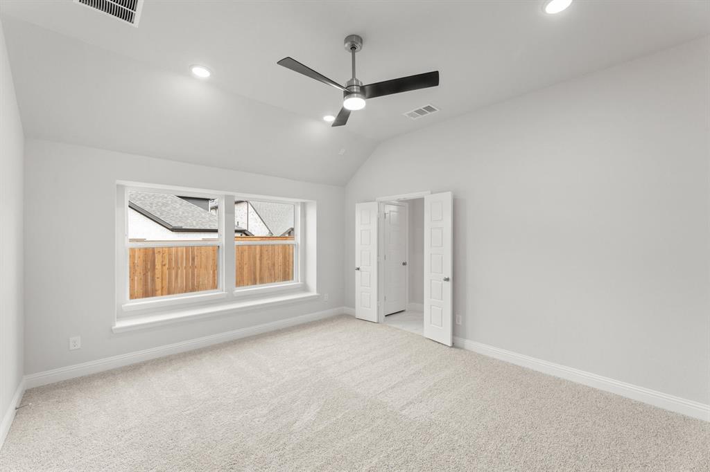 14422 Mietner Street Pilot Point, TX 76258 - Photo 9 of 23 en empty room with windows and ceiling fan