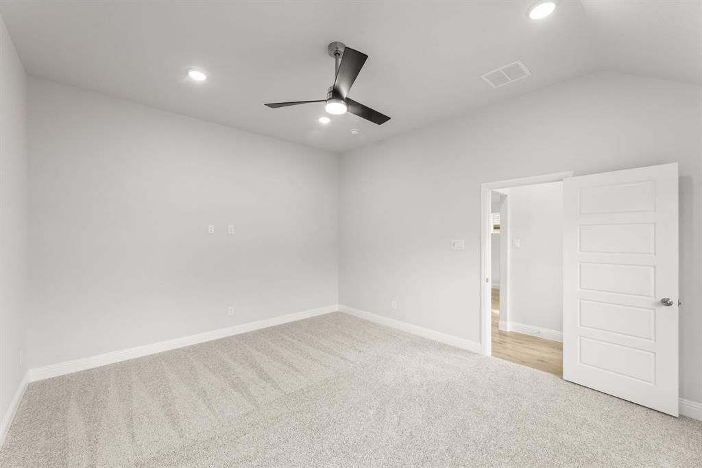14422 Mietner Street Pilot Point, TX 76258 - Photo 10 of 23 an empty room with a ceiling fan and carpet