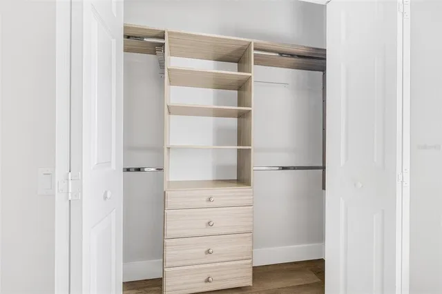 a view of walk in closet with empty racks
