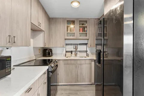 a kitchen with a refrigerator sink and stove