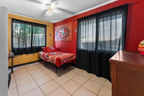 a bedroom with a bed and window