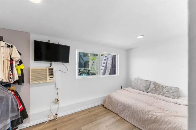 a bedroom with a bed and a flat screen tv