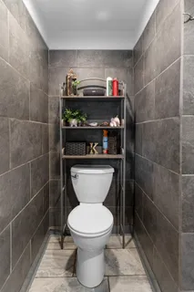 a bathroom with a toilet and a shower