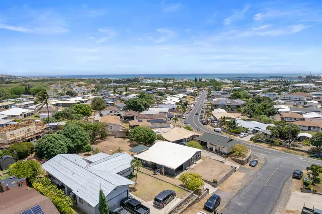 an aerial view of a house with a yard